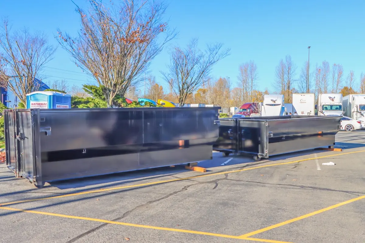 Professional dumpster rental service with roll-off container on residential driveway in Excelsior Springs